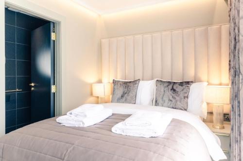 a bedroom with a bed with towels on it at Sweeney Aviemore One in Aviemore