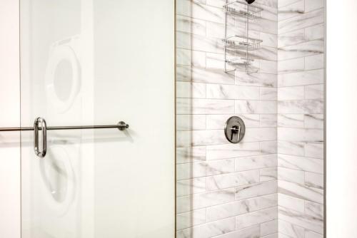 a bathroom with a shower with a glass door at First Hill Studio w Gym Coworking SEA-447 in Seattle