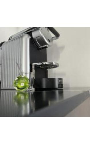 a kitchen counter with a sink with a green liquid at מלון בוטיק H34 in Nahariyya