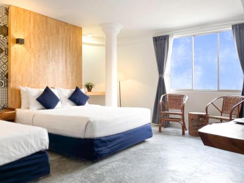 מיטה או מיטות בחדר ב-Pacific Hotel