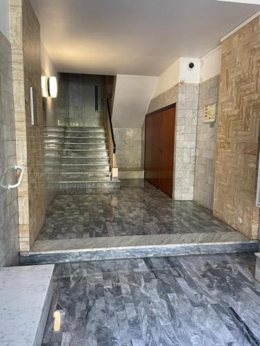 an empty lobby with stairs and a stair case at Très beau deux pièces in Menton