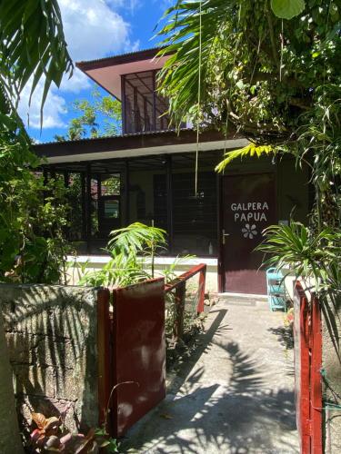 a building with a table and chairs in front of it at Homestay Galpera Papua in Jayapura