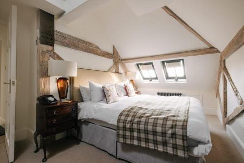 a bedroom with a bed and a night stand with a lamp at Victoria in Holkham
