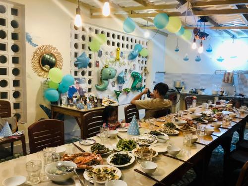 a man taking a picture of a table of food at T'H Homestay in Mui Ne