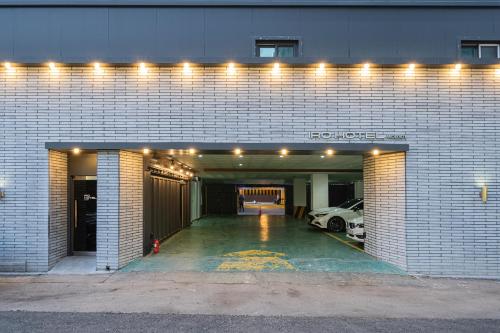 a parking garage with a car parked in it at Iro Hotel Wolgot by ANNK in Siheung