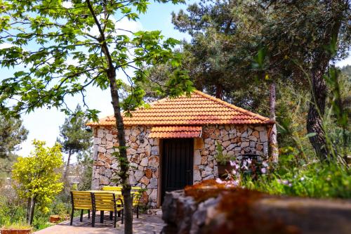 a small stone building with a table and chairs at Graneroverde Resort in Al Qbayyāt