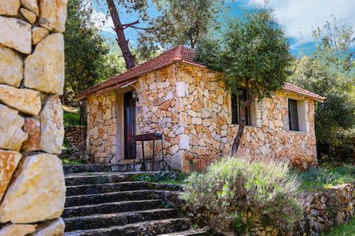 a stone house with stairs leading up to it at Graneroverde Resort in Al Qbayyāt