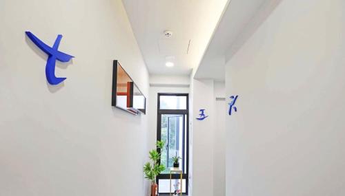 a hallway with white walls and blue signs on the wall at 日月對白 日月潭 2024全新開幕 in Yuchi