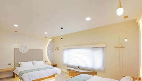 a large bedroom with two beds and a window at 日月對白 日月潭 2024全新開幕 in Yuchi