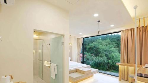 a bathroom with a shower and a window and stairs at 日月對白 日月潭 2023全新開幕 in Yuchi