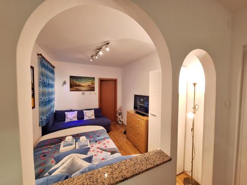 a bedroom with a bed and an archway at Apartment Taya in Piran