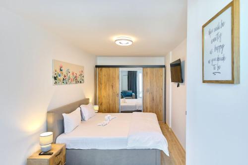 a bedroom with a large white bed in a room at MDApartment in Infinity Beach Resort- Parking in Mamaia