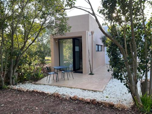 a patio with a table and chairs in front of a house at Villa Pasquy in Specchiolla 