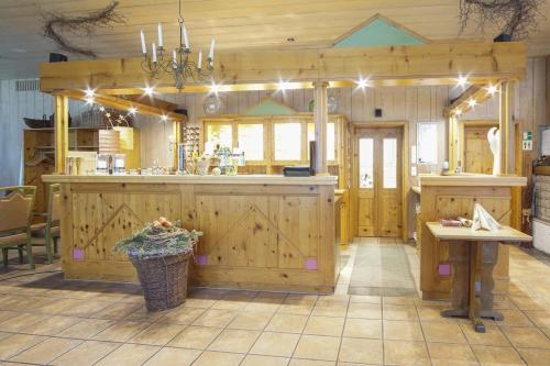 a kitchen with wooden cabinets and a counter top at Naturhotel Forsthaus in Annaberg-Buchholz