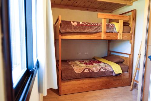 two bunk beds in a room with a window at Graneroverde Resort in Al Qbayyāt
