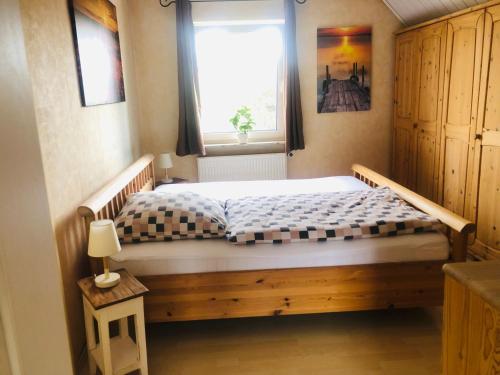 a small bedroom with a bed with a window at Ferienwohnung Ober Widdersheim in Nidda