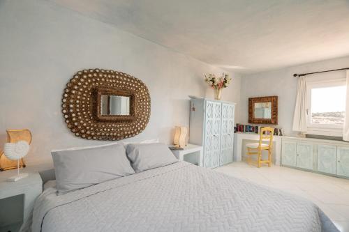 a bedroom with a bed and a mirror on the wall at Casa Silvana by Wonderful Italy in Porto Cervo