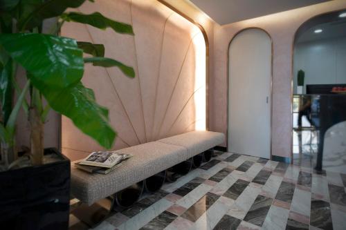a waiting room with a bench with a book on it at Hotel 81 Premier Princess in Singapore
