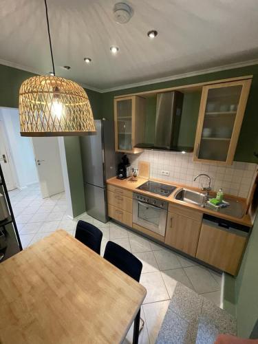 a kitchen with a table and a kitchen with a sink at Homelig Altstadt Ferienwohnung Sassnitz 3 in Sassnitz