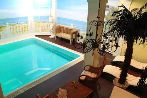 a house with a swimming pool with a view of the ocean at Parkhotel Fischer in Wernigerode