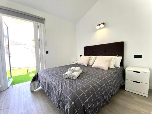 een slaapkamer met een bed met twee handdoeken erop bij New Garden Solarium Bungalow in Maspalomas
