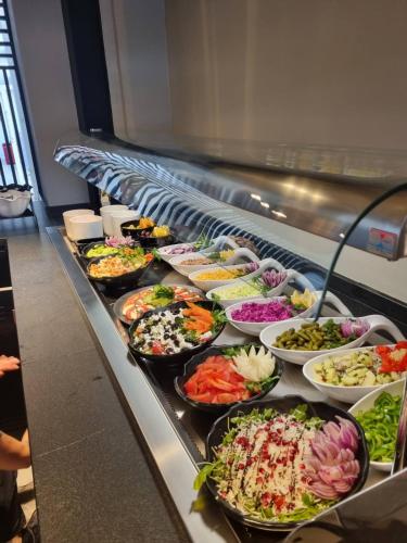 a buffet line with many different types of food at Abacus Suites in Ayia Napa