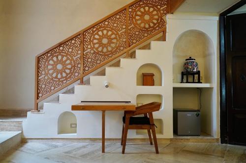 a room with a desk under a staircase at VILLA MERIDA BOUTIQUE HOTEL - Adults Only in Mérida