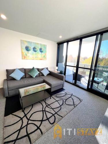 a living room with a couch and a table at Fab in Phillip - 2bd 2bth Apt - Close to CBR Hospital in Phillip