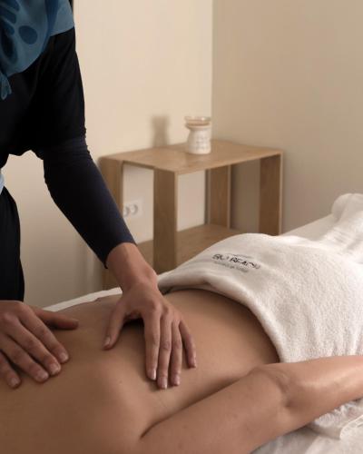 a woman getting her belly pierced by a masseur at BIO BEACH Boutique Hotel - Adults Only in Rethymno Town