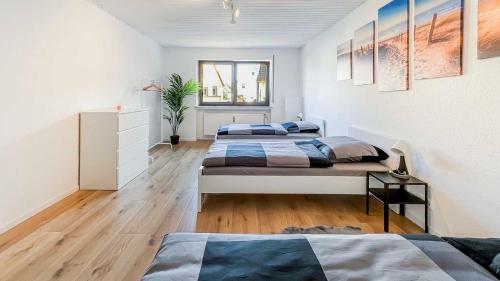 a bedroom with three beds in a room at Houses in Gau-Bischofsheim in Gau-Bischofsheim