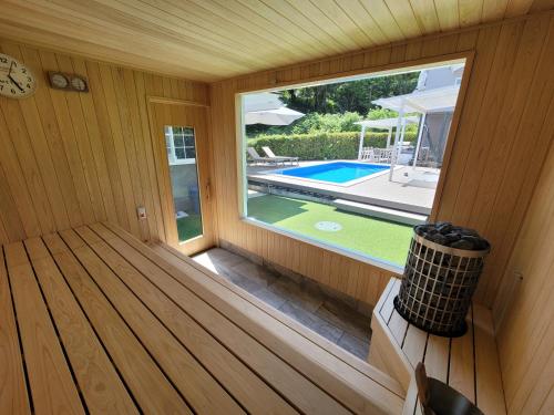 a sauna with a view of a swimming pool at フレッチア in Futo