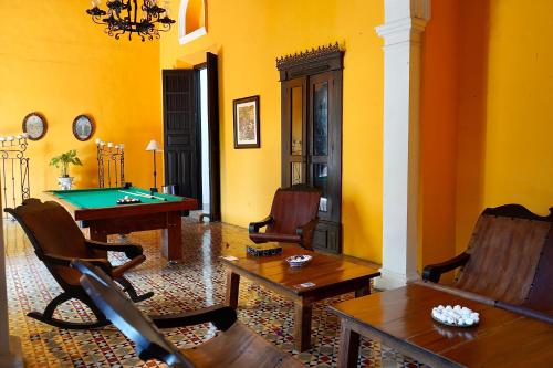 a living room with a pool table and chairs at VILLA MERIDA BOUTIQUE HOTEL - Adults Only in Mérida