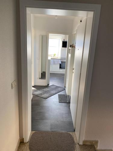 a hallway with a hallway leading to a bedroom at FeWo an der Nordseeküste mit Garage in Wilhelmshaven