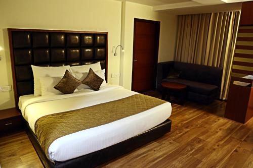 a bedroom with a large bed in a hotel room at Hotel Cama in Chandīgarh
