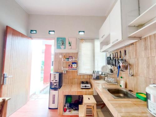 a kitchen with a sink and a counter top at SleepHouse 2BR Cozy Place for StayCation in Cirebon