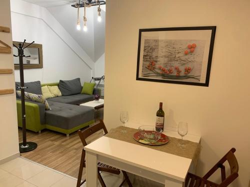 a living room with a table with a bottle of wine at Mavrovo residence, 5 min walk to ski area in Mavrovo