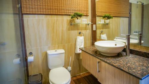 a bathroom with a white sink and a toilet at Warwick Centre Furnished and Serviced Apartments in Nairobi