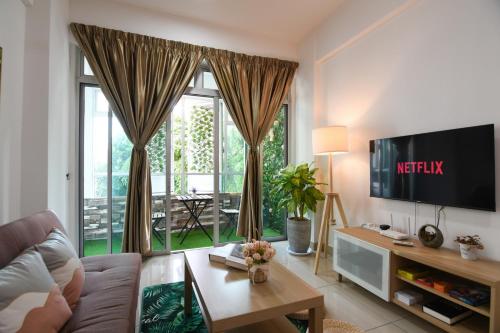 a living room with a couch and a large window at Mount Austin Midori Green 10 Pax Free Wi-Fi 500Mbps Netflix in Johor Bahru