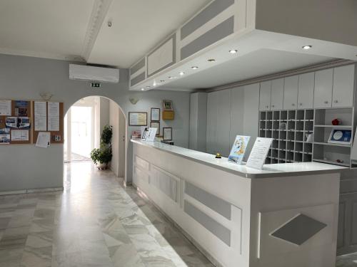 a kitchen with a white counter and a hallway at Albatros Hotel in Karterados
