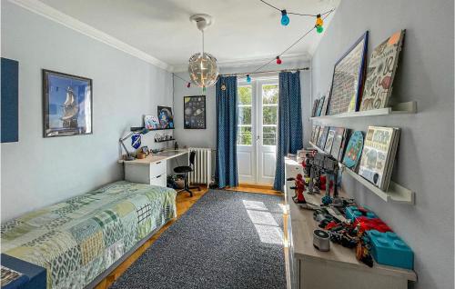 a bedroom with a bed and a desk and a window at Amazing Home In Gteborg With Wifi in Gothenburg