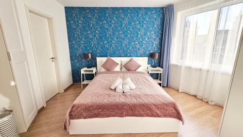 a bedroom with a large bed with two white pillows at L&L HOME in Budapest