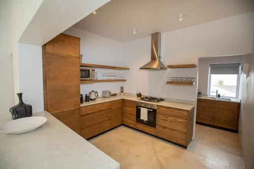 a large kitchen with wooden cabinets and a sink at Lucky Crane Villas in McGregor