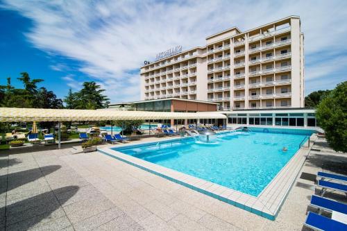 a hotel with a swimming pool in front of a building at Hotel Terme Antoniano in Montegrotto Terme
