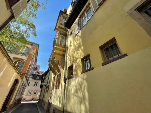 an alley between two buildings in a city at Hôtel Patricia - Strasbourg Hyper Centre in Strasbourg