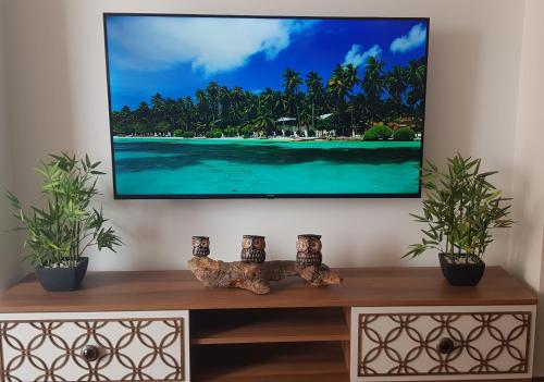 a tv screen hanging on a wall in a living room at apartamento la perla in Fuengirola