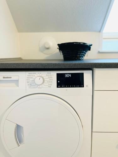 a washing machine with a counter on top of it at Scandinavian Apartment Hotel - Lunden 1 - Central 3 bedroom apartment on two floors in Horsens