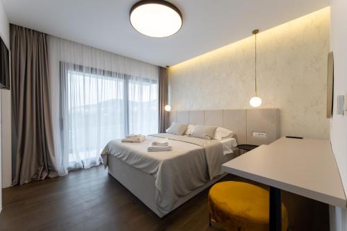 a hotel room with a bed and a large window at Villa Duje in Kastel Stari