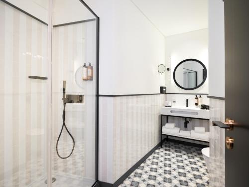 a bathroom with a shower and a sink at Axis Porto Club Aliados in Porto