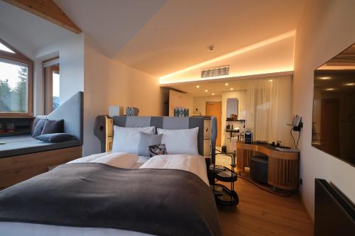 a bedroom with a large bed and a living room at Lesehotel in Bad Goisern