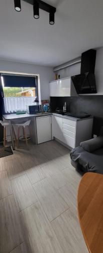 a kitchen with a desk and a table in a room at Pod Chmurką in Solina